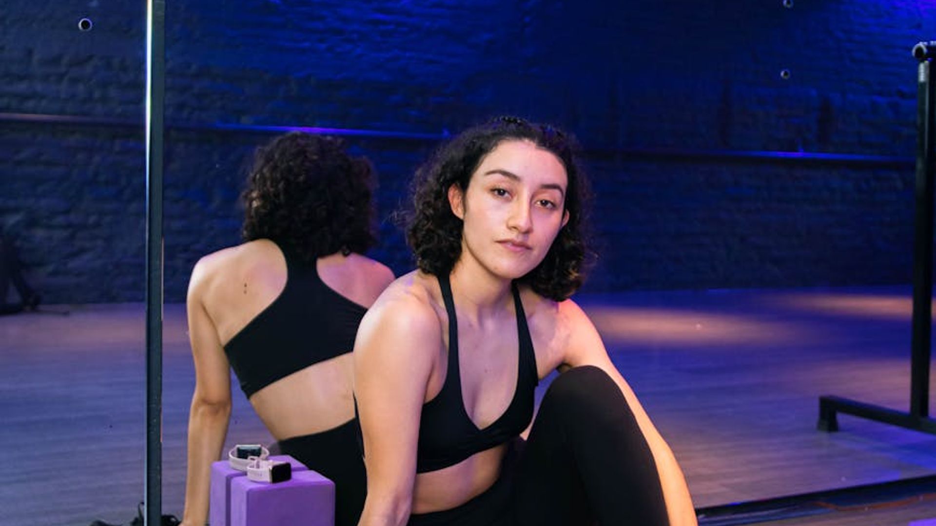 Modern fitness studio interior with neon lighting and equipment